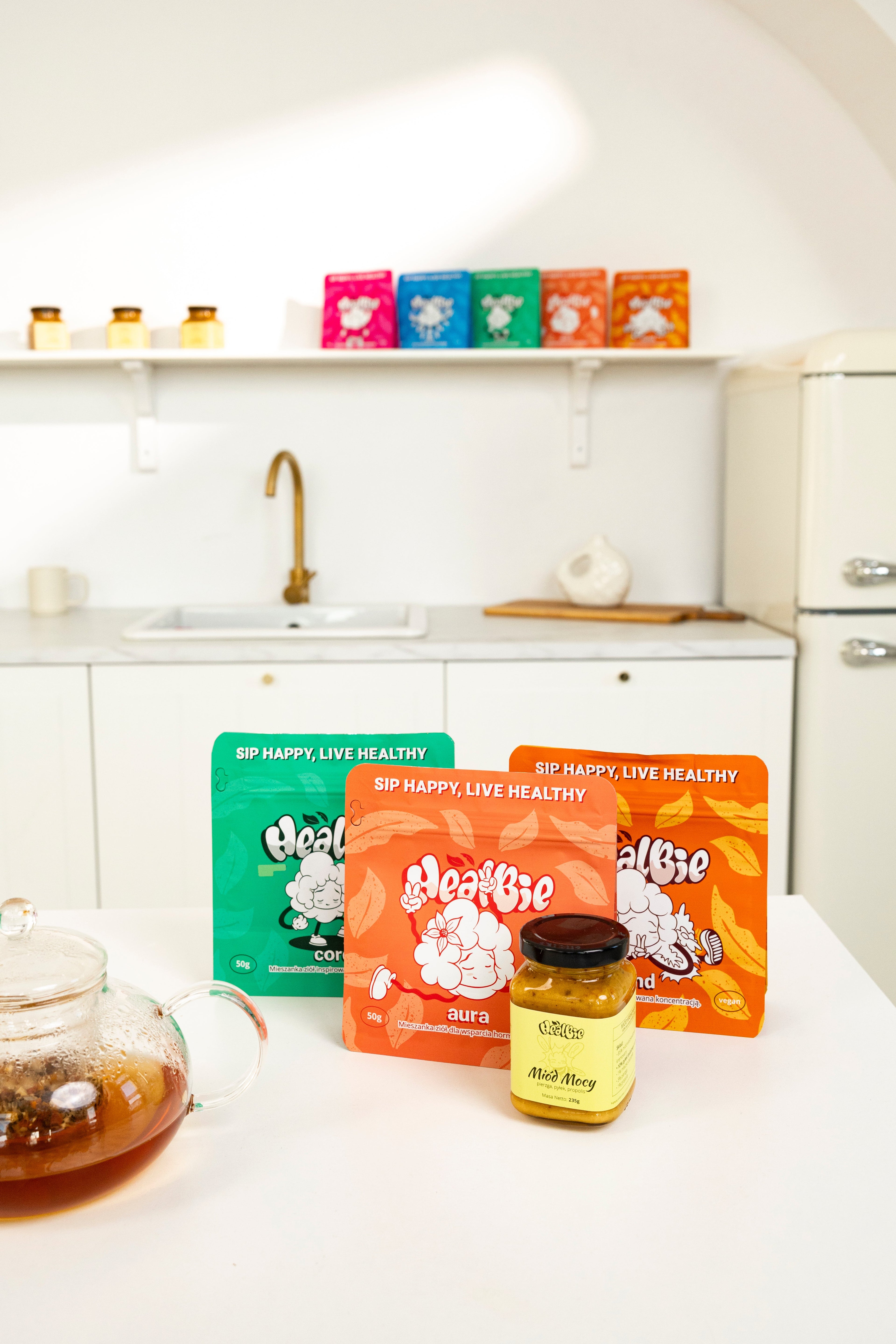 herbaty ziołowe aura, core, mind i miód mocy wielokwiatowy na stole